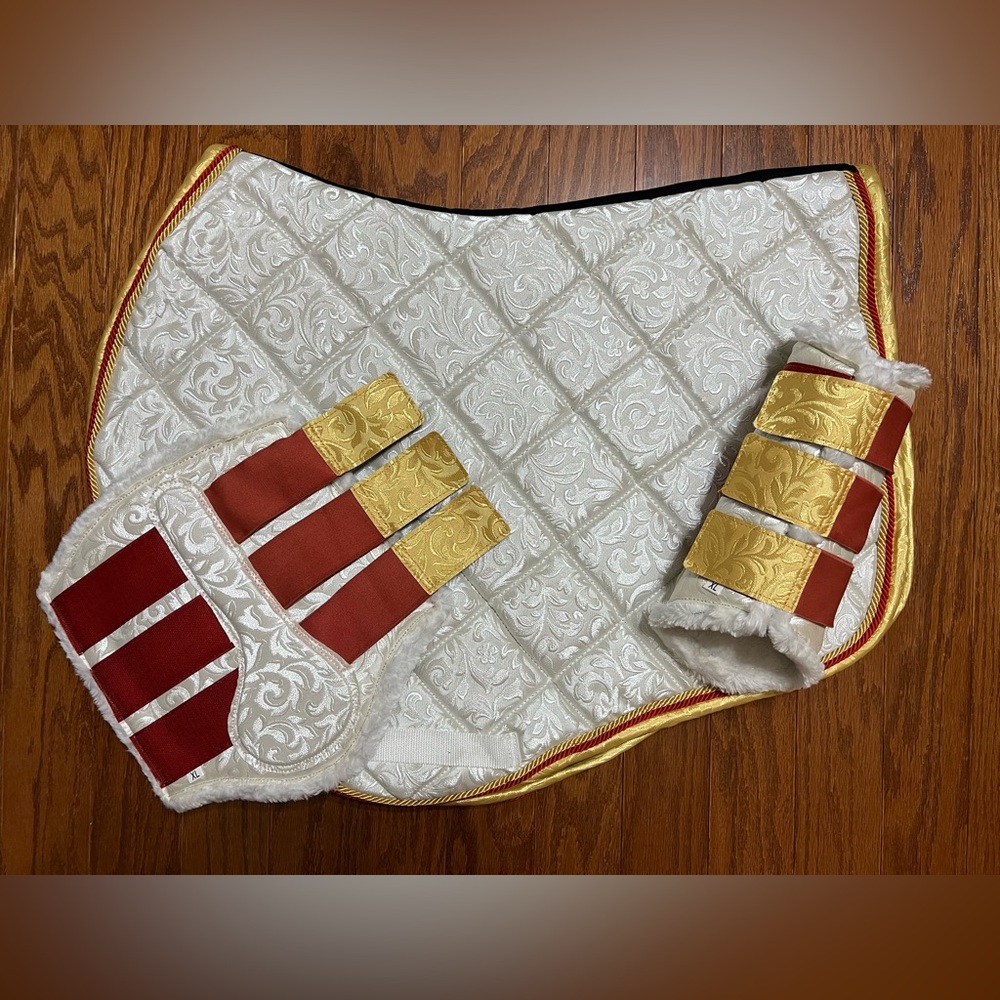 White patterned jump cut saddle pad with gold and red cording with OS boots